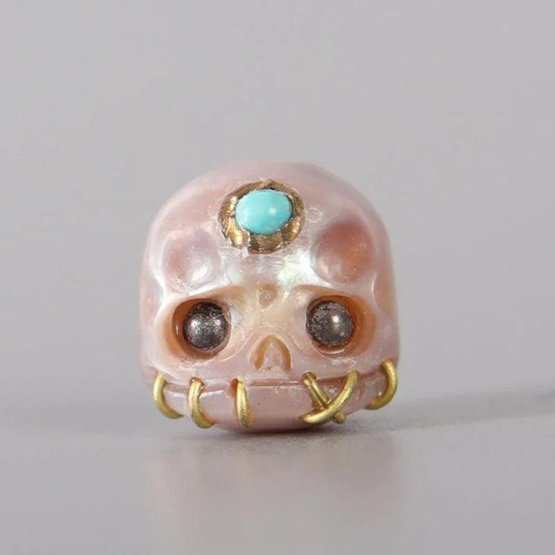 Belle Juri Light Orchid Pearl Carved Śmaśana Skull Bead With Golden & Black Eyes