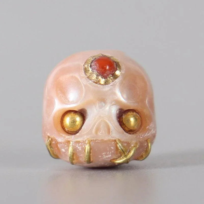 Belle Juri Light Orchid Pearl Carved Śmaśana Skull Bead With Golden & Black Eyes