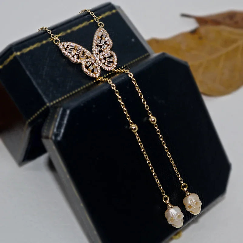 Collana a ciondolo per ali cranio gembo di gemma di gemme dorate