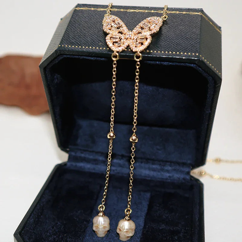 Collana a ciondolo per ali cranio gembo di gemma di gemme dorate