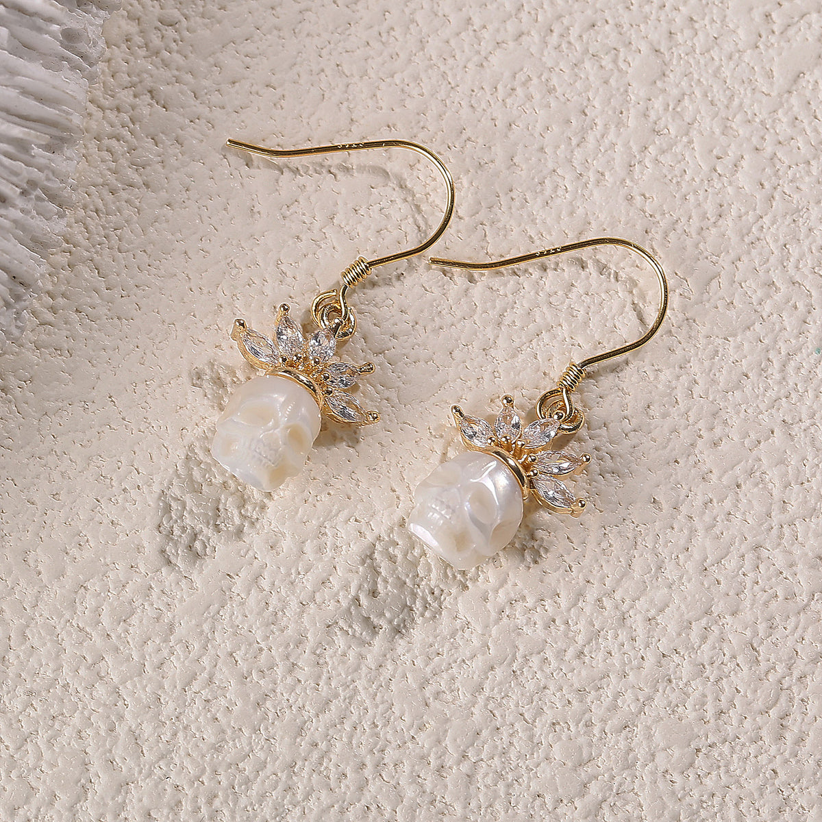 Zircon Crowned Carved Pearl Skull Earrings