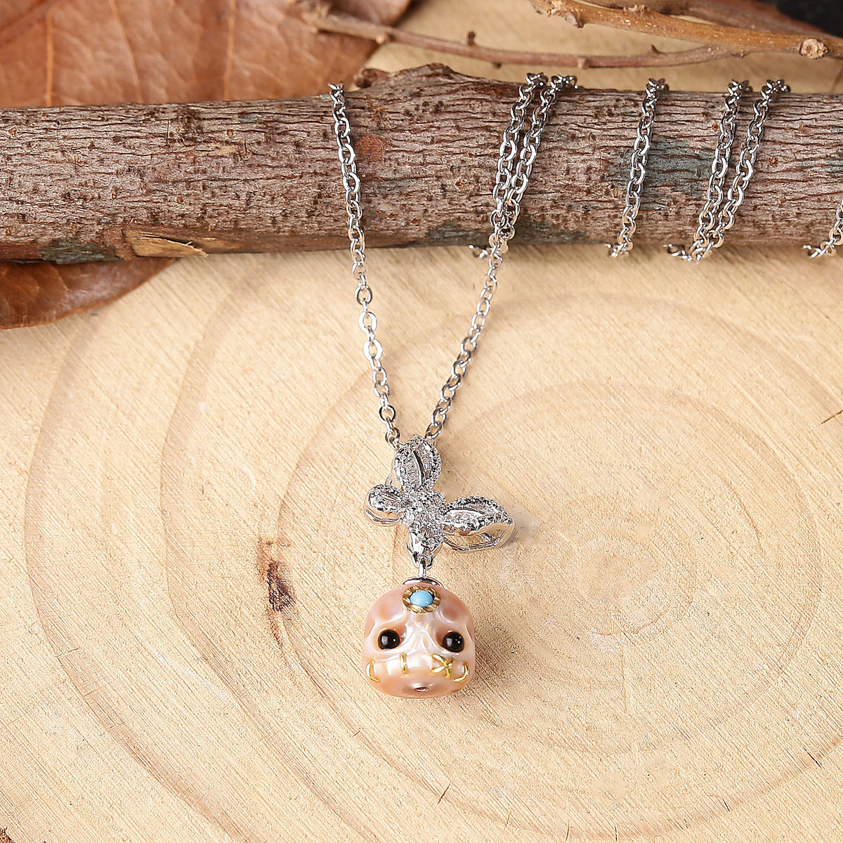 Flying Zircon Butterfly Śmaśana Carved Pearl Skull Necklace