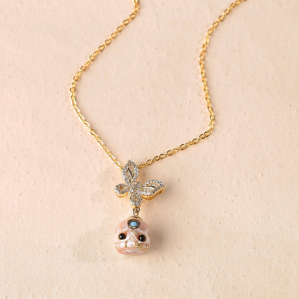 Flying Zircon Butterfly Śmaśana Carved Pearl Skull Necklace
