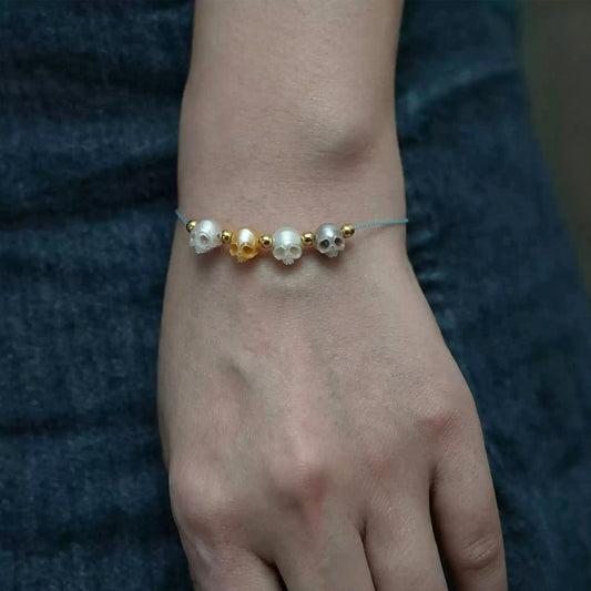 Hand-carved natural pearl bracelet with braided wax cord