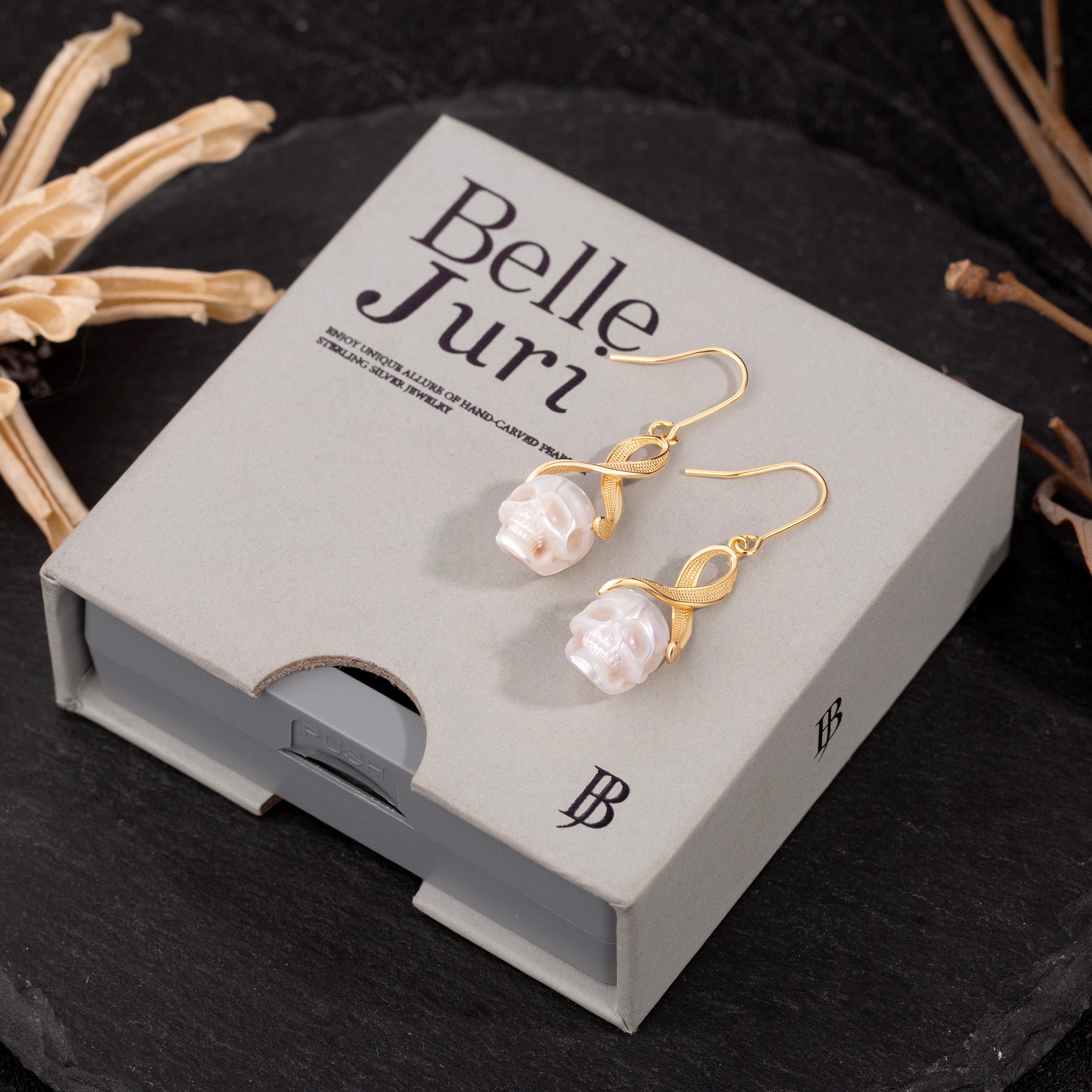 Interlaced Ribbon Pearl Skull Earrings