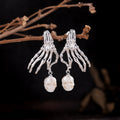 Boucles d'oreilles en peigne de perle de squelette punk