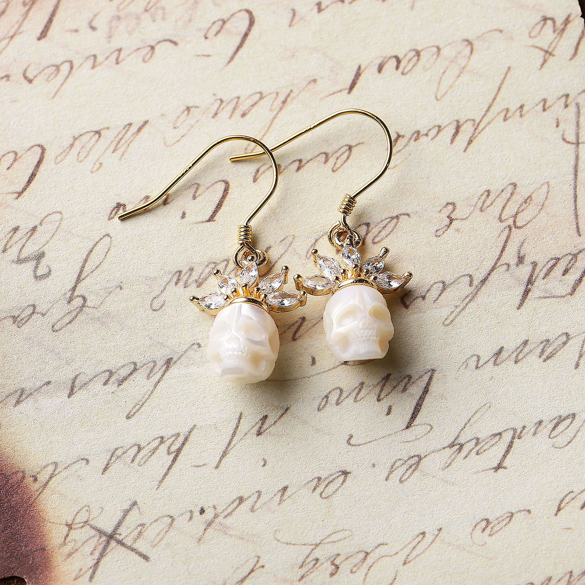 Zircon Crowned Carved Pearl Skull Earrings