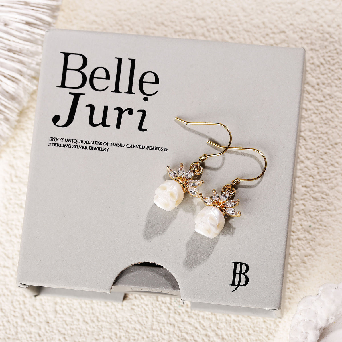 Zircon Crowned Carved Pearl Skull Earrings