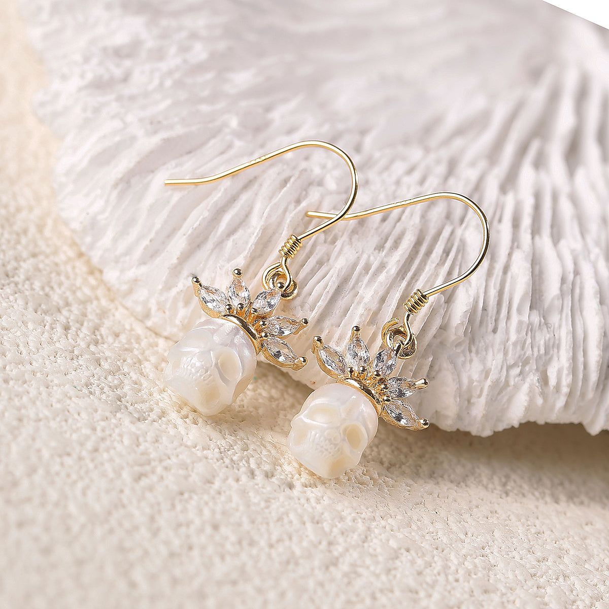 Zircon Crowned Carved Pearl Skull Earrings