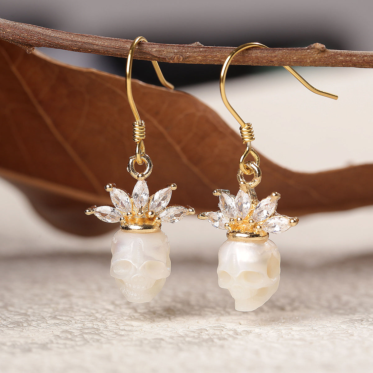 Zircon Crowned Carved Pearl Skull Earrings