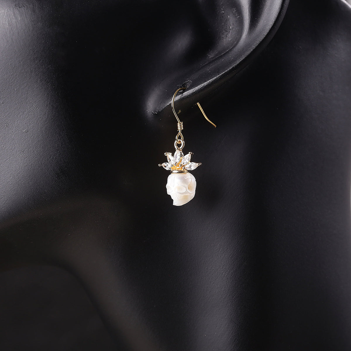 Zircon Crowned Carved Pearl Skull Earrings
